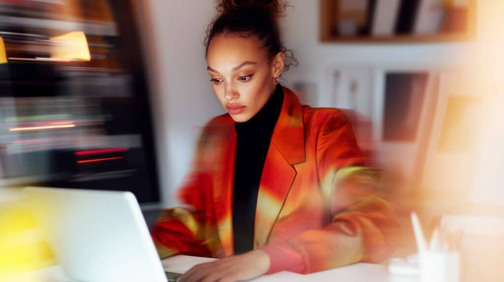 Creative professional working on a laptop, representing the field of Motion Graphics design.